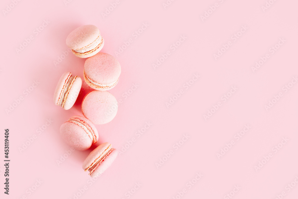 Tasty french macarons on a pink pastel background. Tasty french macarons on a pink pastel background.