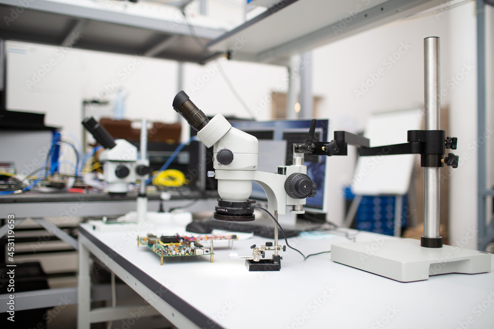 Microscope and electronic board in Scientific research tech Laboratory on table. Microscope and electronic board in Scientific research tech Laboratory on table.