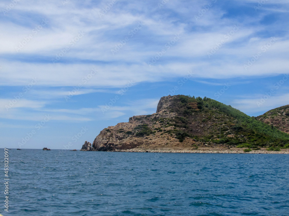 Rocky mountain range shaped like a dog's head protruding from the sea in Cu Mong lagoon, Phu Yen