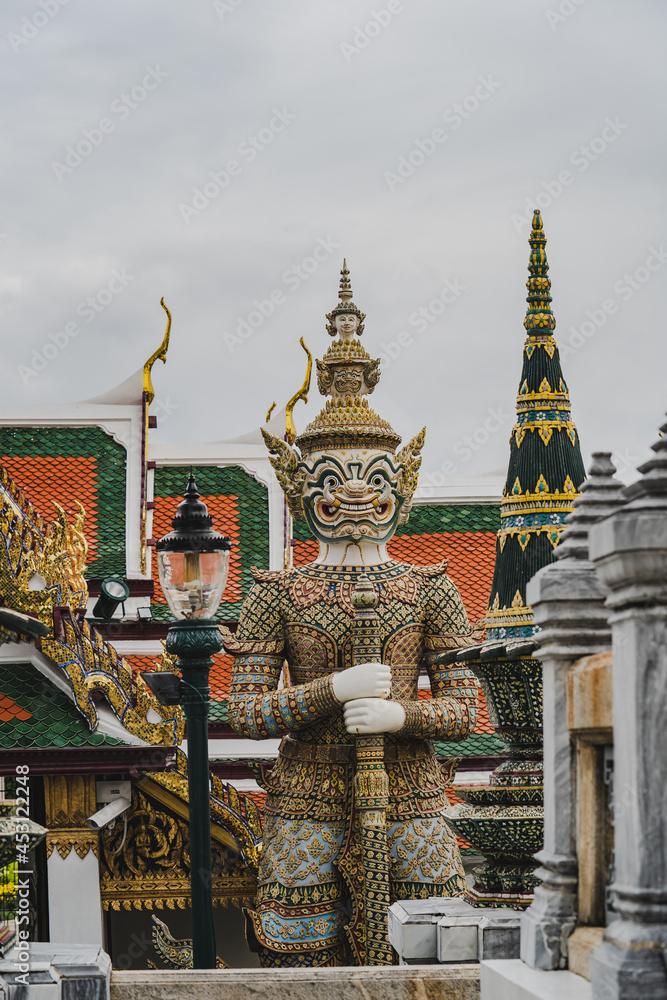 Giant statue at the grand palace the Temple of the Emerald Buddha. Giant statue at the grand palace the Temple of the Emerald Buddha.