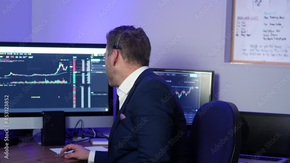 Forex cryptocurrency trader analyst broker talking and selling to a customer and checking the trading graphs and signals on monitor screens. Forex cryptocurrency trader analyst broker talking and selling to a customer and checking the trading graphs and signals on monitor screens.