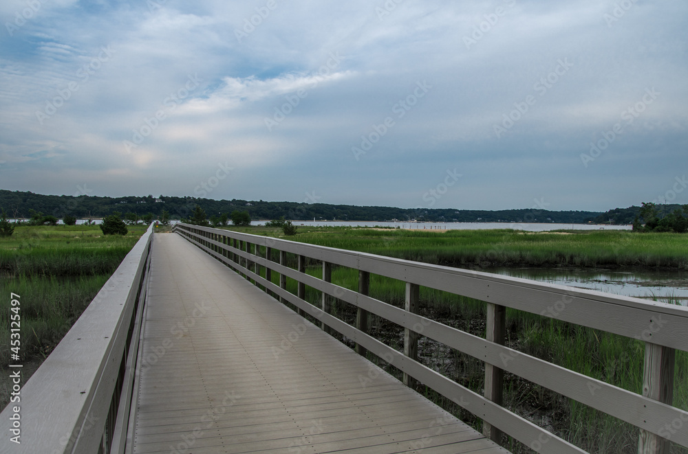 a long wood walkway over the wetland to the beach