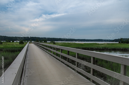 a long wood walkway over the wetland to the beach
