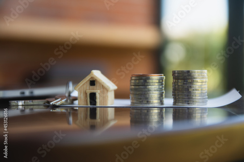 Home loan coins stack on table computer side view background concept money business investment