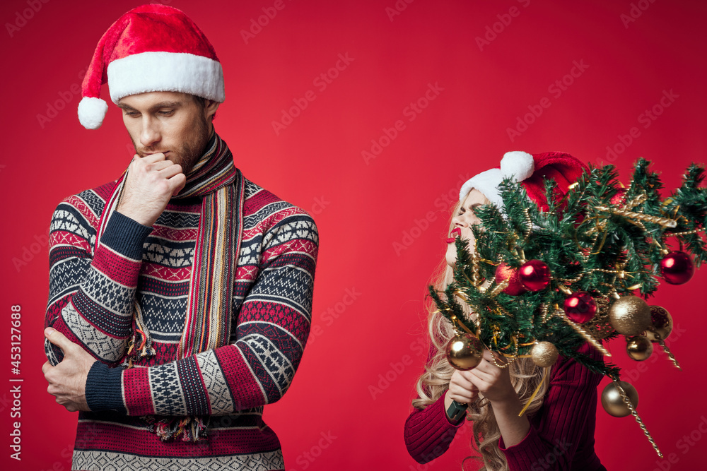 man and woman new year tree decoration holiday red background man and woman new year tree decoration holiday red background