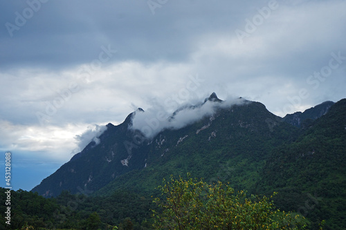 Natural landscape of green mountain range with cloudy blue sky