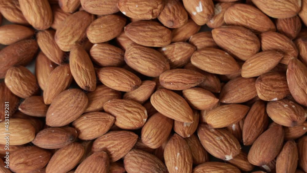Pile of peeled raw almonds as a background. Rotation Pile of peeled raw almonds as a background. Rotation