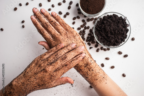 Schilderij op canvas Young woman hand applying coffee grounds scrub massaging cosmetic skincare