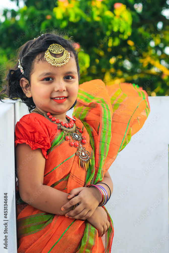Indian little girl in traditional saree and jewelry. Cute Indian little
