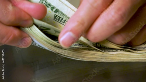 Men counting of US Dollar bank notes on glass table