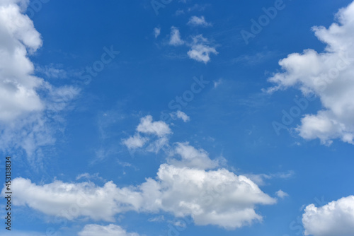 Beautiful cumulus clouds against the blue daytime sky.