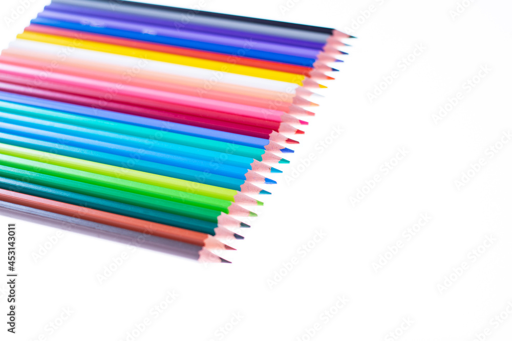 24 multicolored crayons on a white background, neatly arranged and sharpened. Hello School. 24 multicolored crayons on a white background, neatly arranged and sharpened. Hello School.