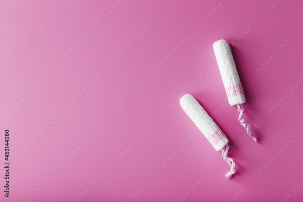 Gynecological tampons on a pink background free space Gynecological tampons on a pink background free space