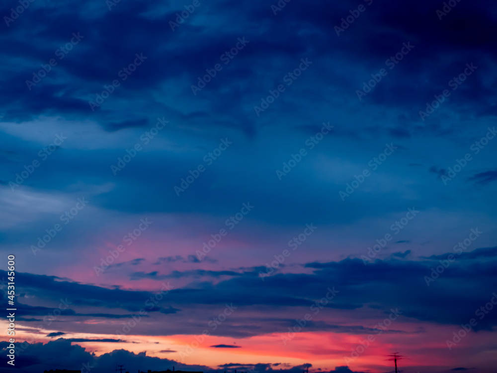 Panorama evening sky with blue, white and orange clouds.