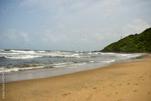 Ocean-Sea Waves Beach Sand and Mountains Yellow Landscape Background
