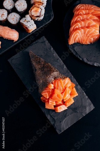 Temaki salmon on the background dark top view