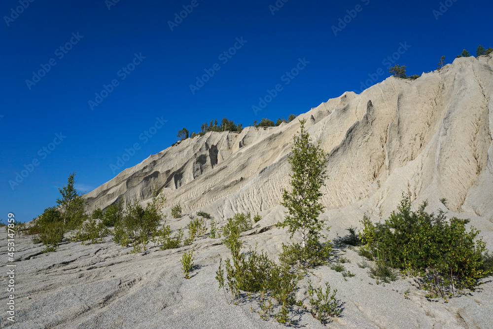 abstract view of limestone and sandstone mountains with sharp edges under a cloudless sky