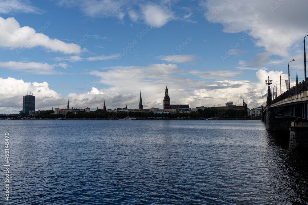the Daugava River and Akmens Tilts Bridge with the skyline of Riga in the background the Daugava River and Akmens Tilts Bridge with the skyline of Riga in the background