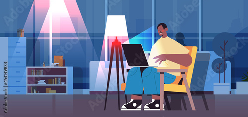 overworked businessman freelancer looking at laptop screen man sitting at workplace in dark night home room