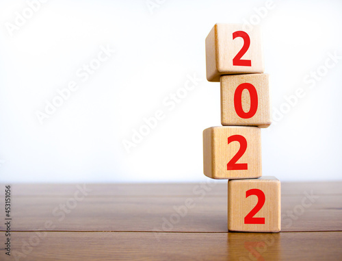 2022 happy new year symbol. Wooden cubes symbolize the change from 2021 to the new year 2022. Beautiful white background. Copy space. Business and 2022 happy new year concept.