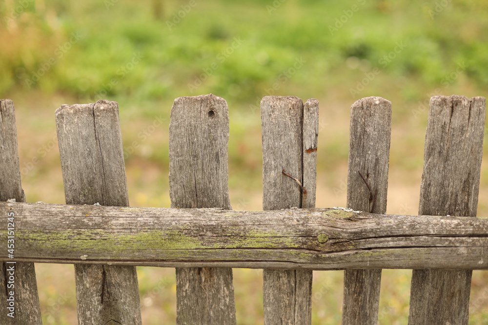 Old wooden fence and meadow.