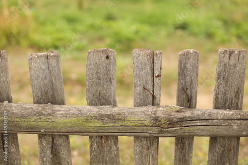 Old wooden fence and meadow.