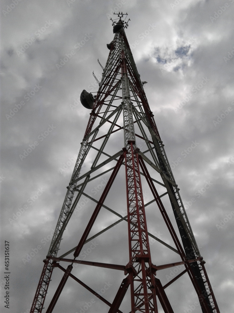 Communication Tower Against a Cloudy Sky Communication Tower Against a Cloudy Sky