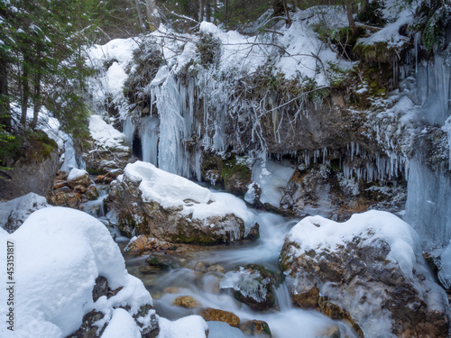 Frozen small river in the Fassa Valley (Italy) © Andrea