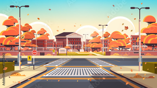 school building empty front yard with road crosswalks autumn cityscape background