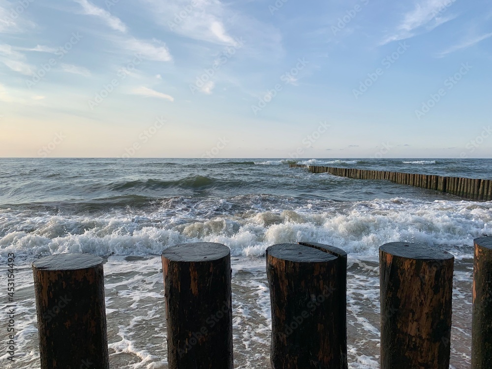 Breakwater construction in the sea, sea horizon, natural colors, romantic atmosphere Breakwater construction in the sea, sea horizon, natural colors, romantic atmosphere