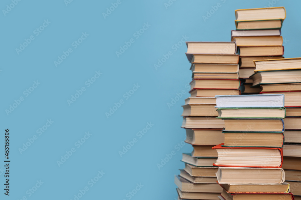 Many hardcover books on turquoise background, space for text. Library material Many hardcover books on turquoise background, space for text. Library material