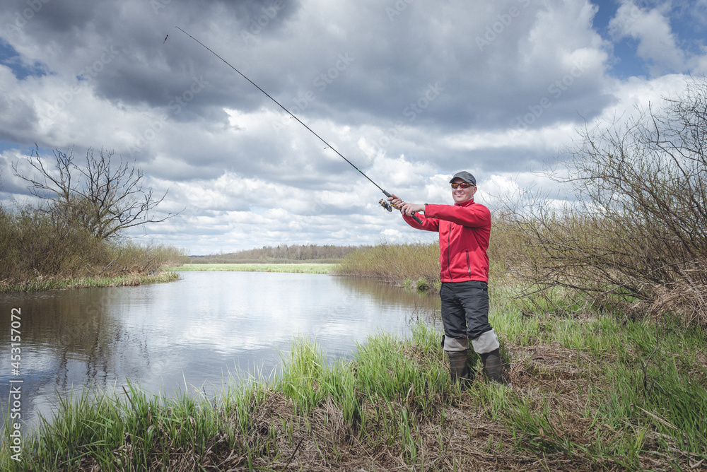 Fisherman in red clothes is fishing. Fisherman in red clothes is fishing.