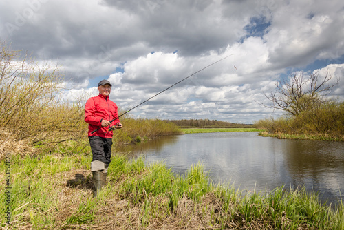 Fisherman in red clothes is fishing.