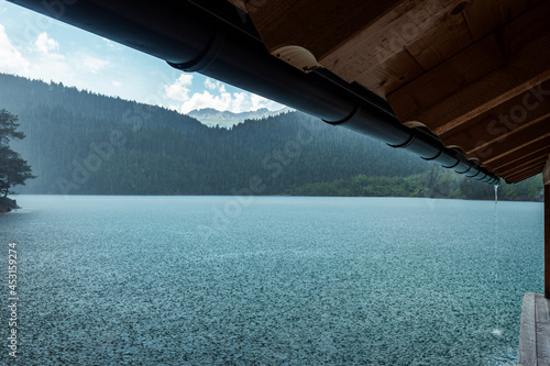 a view to Blindsee lake from a boat shed during a rain