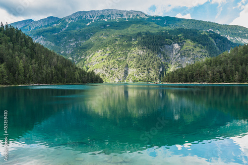 a beautiful view to a mountain and Blindsee lake with it's emerald green water