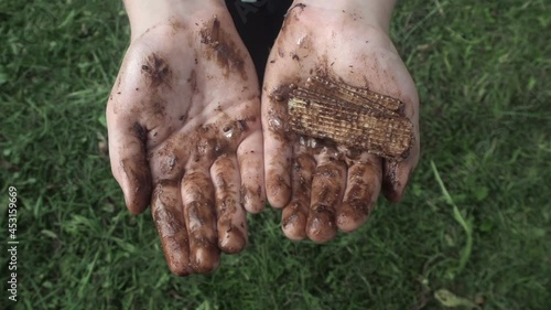 Children hands in chocolate on green background 