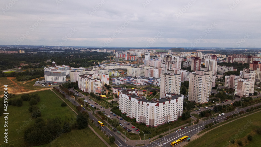 City block. Modern multi-storey buildings. Flying at dusk at sunset. Aerial photography.