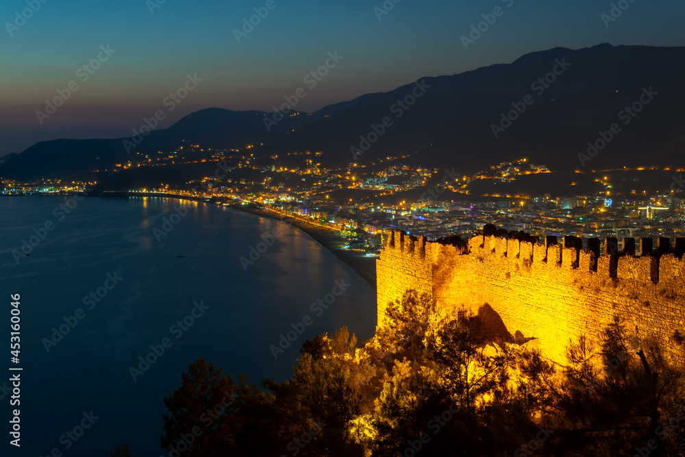 View from the fortress. Stone walls. Lighting and night atmosphere. Touristic point. View of the city lights. Leisure and tourism in Turkey, Alanya
