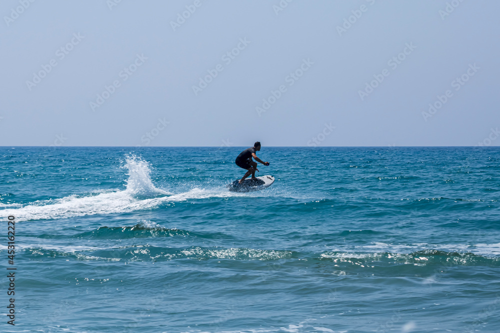 Unrecognizable surfer in the sea