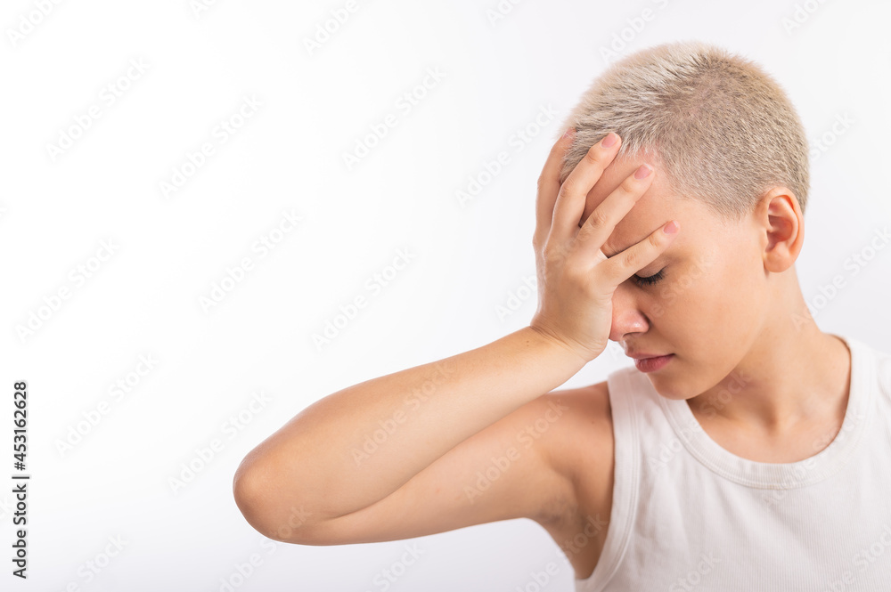 Young caucasian woman with short hair with a palm on her face on a white background. Young caucasian woman with short hair with a palm on her face on a white background.