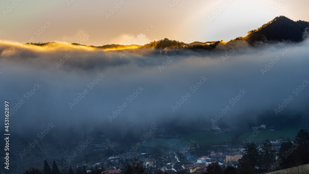 The autumn morning shows us its three pictures in one: sunrise, dense fog and a town hidden under a layer of rising fog.
