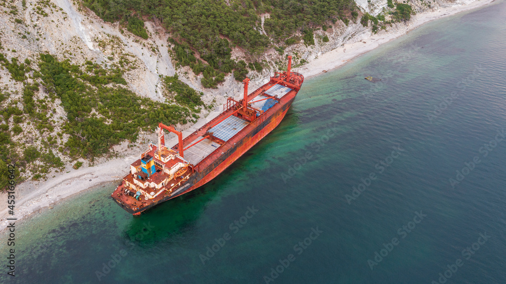Sea tanker, dry cargo ship, washed ashore after a storm, aerial view Sea tanker, dry cargo ship, washed ashore after a storm, aerial view