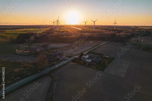 Fototapeta Naklejka Na Ścianę i Meble -  Aerial photo of windmills and blue sea at sunset