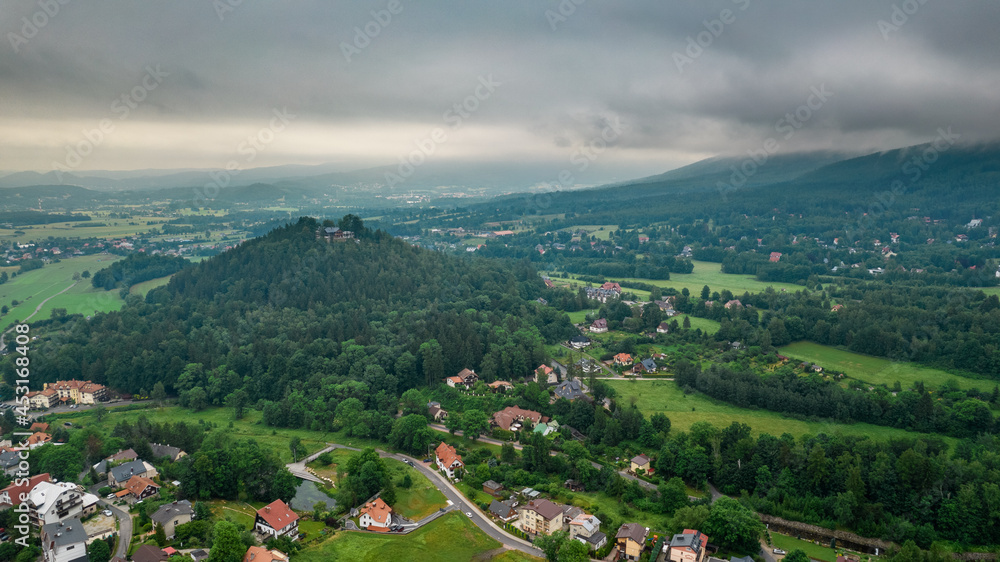 Aerial drone view, small typical polish villagesurrounded by beautiful mountains at summer.