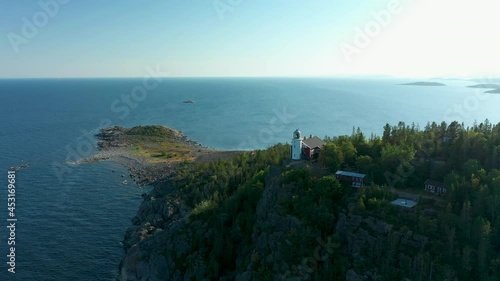 Aerial view of lighthouse high up on a cliff rock photo
