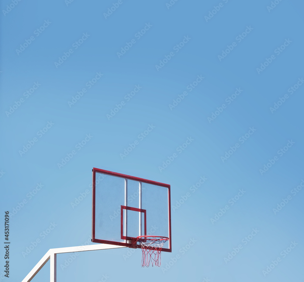 Basketball hoop on a clean blue sky. Sports wallpaper or background. Poster for basketball competition. Modern minimalistic style photography. Lifestyle sport shoot. High quality photo Basketball hoop on a clean blue sky. Sports wallpaper or background. Poster for basketball competition. Modern minimalistic style photography. Lifestyle sport shoot. High quality photo
