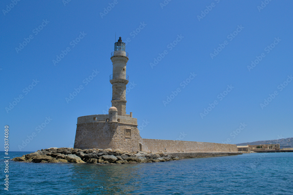 Sea lighthouse in summer in sunny cloudless weather.