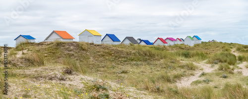 Gouville-sur-Mer, Normandy, colorful wooden beach cabins in the dunes
