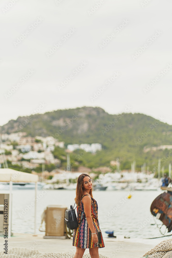 Young spanish woman smiling at camera on Port d'Andratx, Mallorca