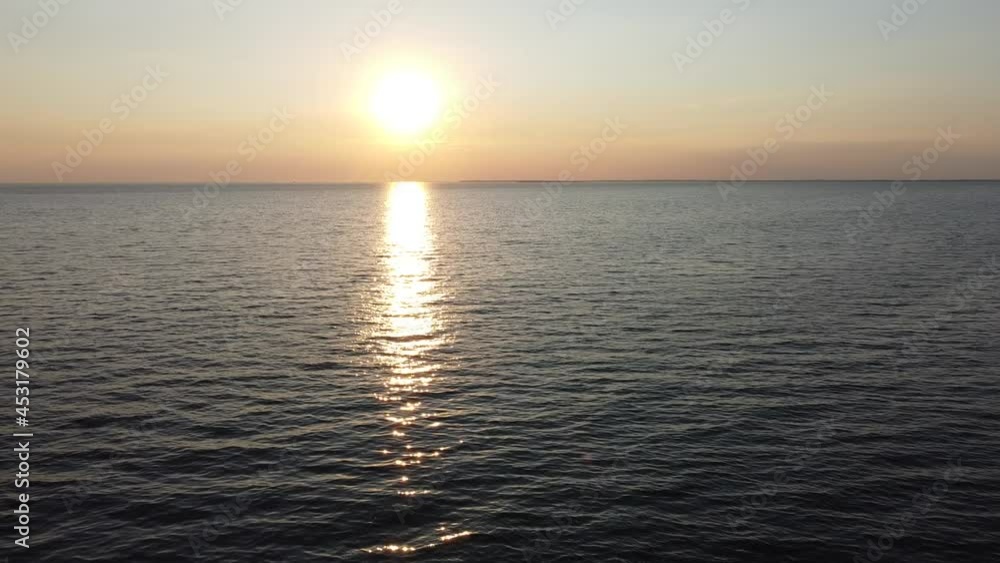 Aerial of sunset on the paradise island. Golden hour with yellow sun diving to the sea. Drone video of the ocean in the evening. Panorama of the sky and water on blue horizon harmony view. Aerial of sunset on the paradise island. Golden hour with yellow sun diving to the sea. Drone video of the ocean in the evening. Panorama of the sky and water on blue horizon harmony view.
